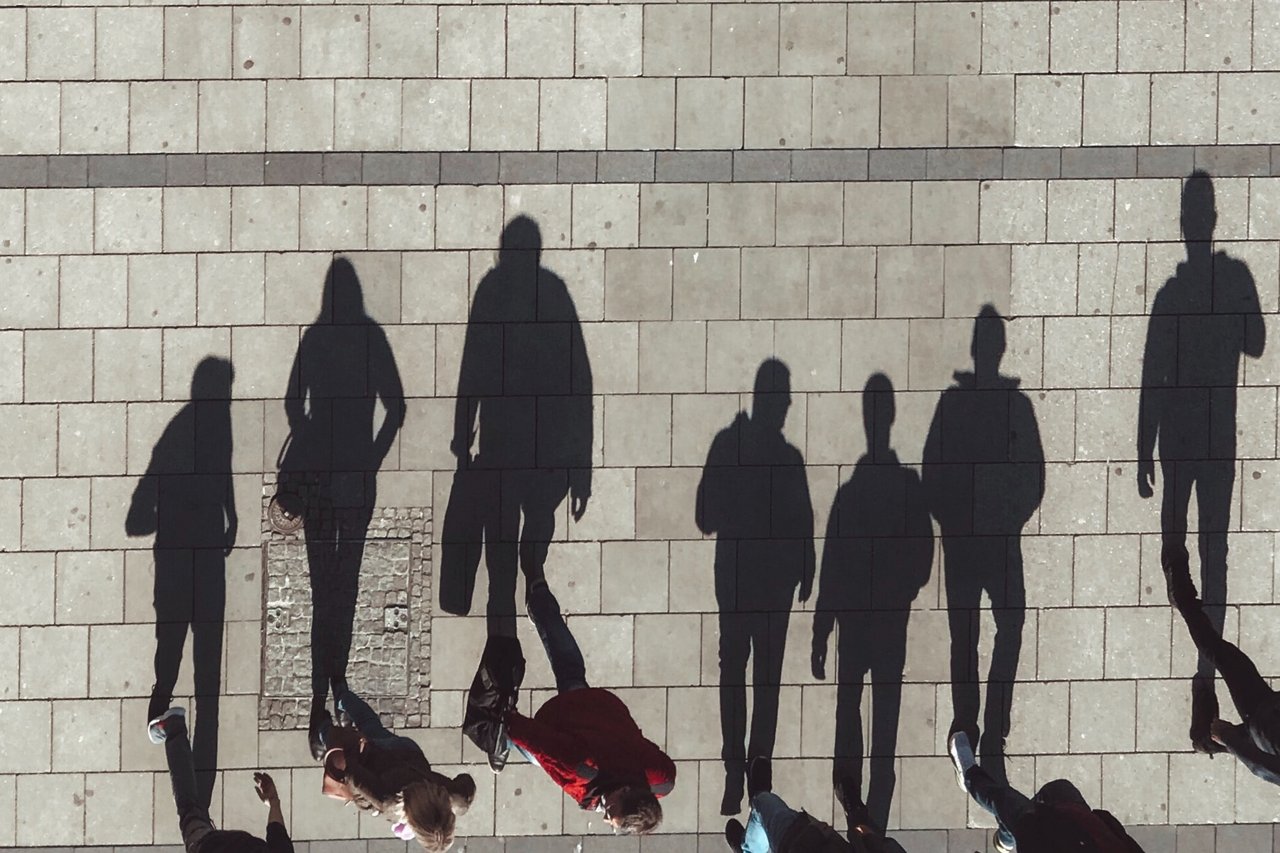 Spaziergänger von oben mit ihrem Schatten fotografiert