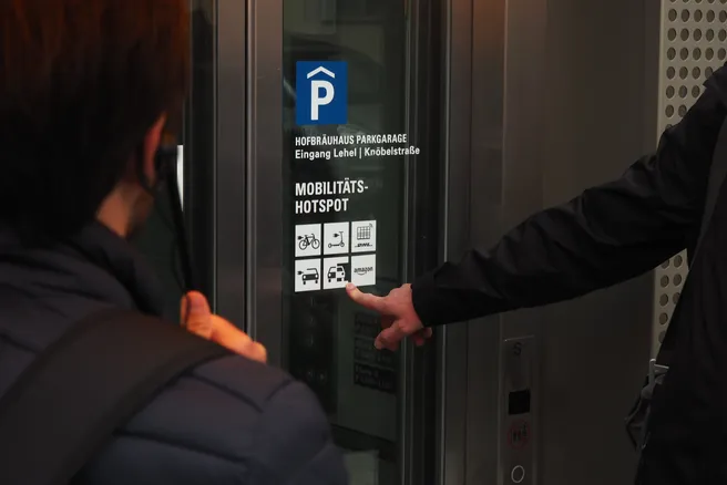 A finger is pointed at various mobility symbols on a lift disc.